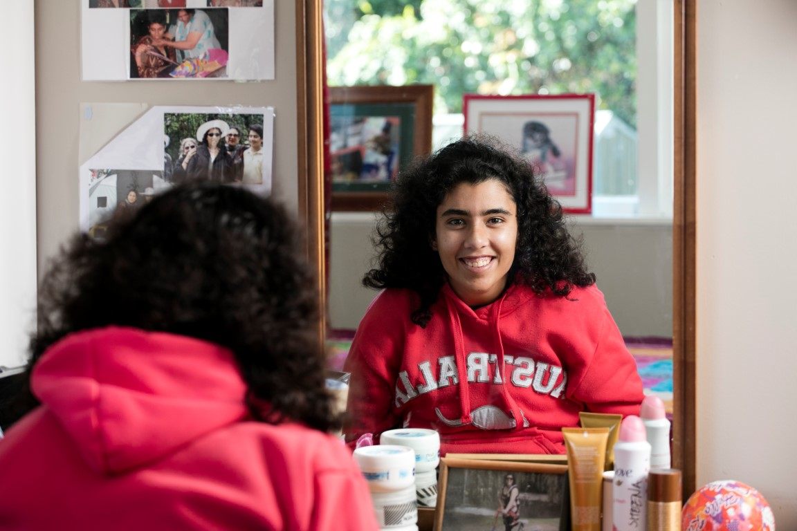 Girl sitting in front of mirror